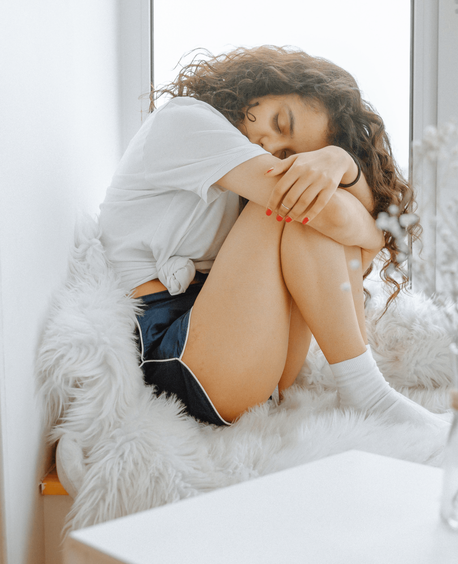 woman resting her head on her knees